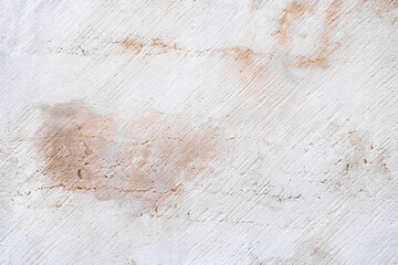 Textured white concrete wall with subtle stains and marks showing natural aging over time