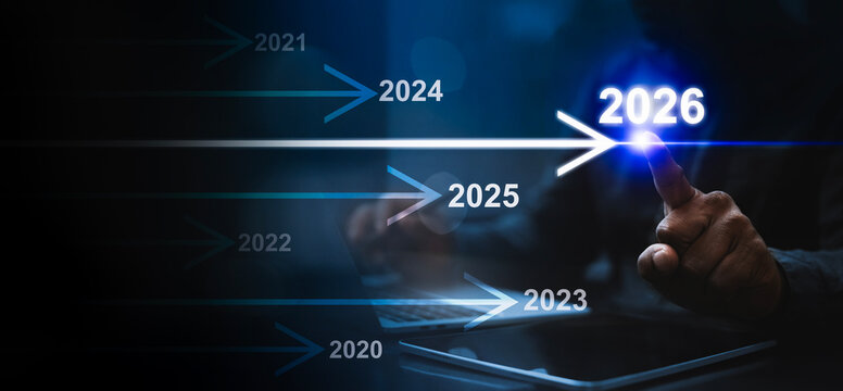 Timeline to 2026 – Business Growth and Future Strategy, A futuristic business timeline concept moving from 2020 to 2026. A hand points toward the glowing year 2026.