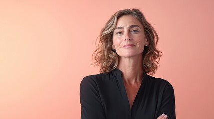 Confident Woman with Natural Beauty Posing Against a Soft Coral Background