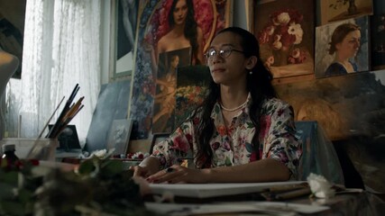 Artist painting in a creative studio surrounded by inspiring artwork