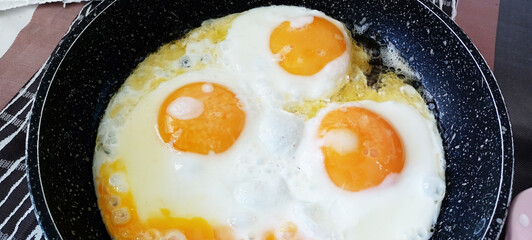 Eggs close in a frying pan