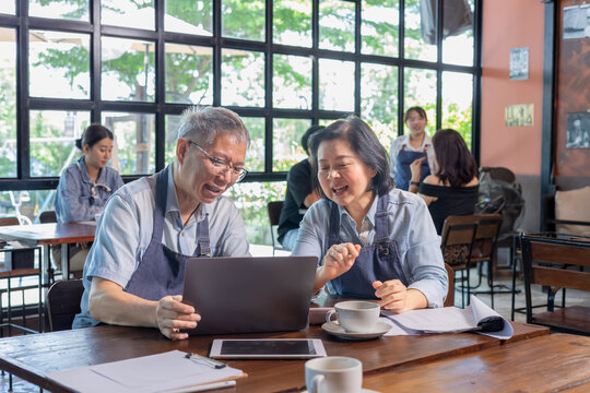 Restaurant senior couple owners small business receiving online order while serving customer, technology purchasing digital service dining, Asian husband and wife happy startup business success