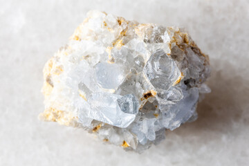 sample of rough celestine rock on white marble