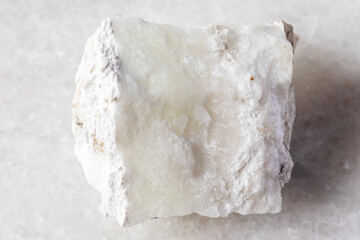 sample of raw pinnoite mineral on white marble