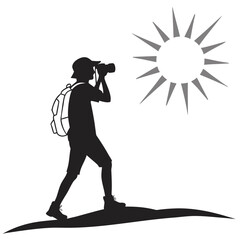 Hiker photographing sunrise silhouette