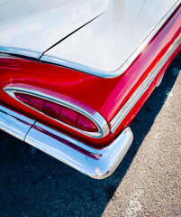 Tail Fin and Bumper of a Red and White Car