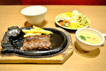 A Complete and Balanced Meal: Grilled Hamburg Steak Platter with a Side of Salad and Rice