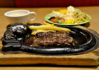 A Complete and Balanced Meal: Grilled Hamburg Steak Platter with a Side of Salad and Rice