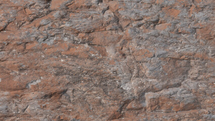 Detailed close up of natural brown and gray marble rock surface providing a rugged and textured...
