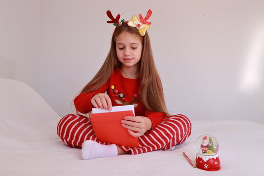 Little girl writing a New Year's letter for Santa Claus