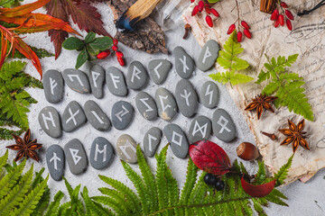 Runes on stones among autumn leaves