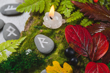 Runes on stones among autumn leaves