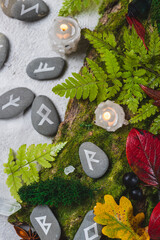 Runes on stones among autumn leaves