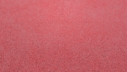 Soft textured red marble surface with speckled granular details evoking a tactile and sophisticated aesthetic perfect for designs requiring depth and a unique background