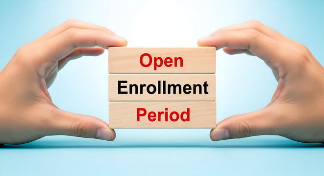 Hands holding wooden blocks spelling out open enrollment period concept