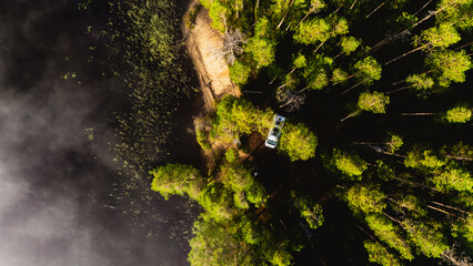 Discover the breathtaking beauty of Hossa National Park, Finland. This aerial view showcases vibrant green trees lining the serene lake, creating a perfect escape in nature.