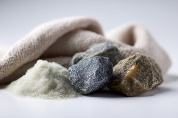 closeup view of diverse textures that includes sand pebbles fabric and wood