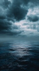 Fototapeta premium High quality image of moody seascape with dark clouds and sunlight reflecting on the water.