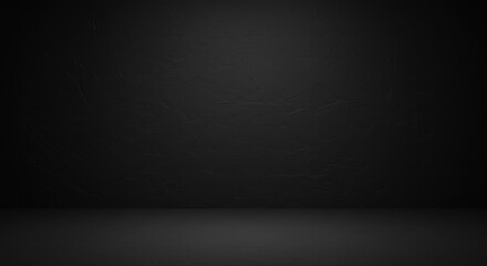 A dark, empty studio space with a textured black background and floor.
