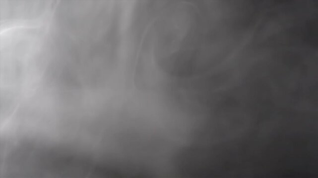 Abstract smoke patterns elegantly swirling on a dark background, ideal for a wide range of creative projects