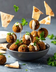 Levitating Falafel Balls with Tahini Drizzle, Fresh Parsley, and Pita Crumbs Mid-Air