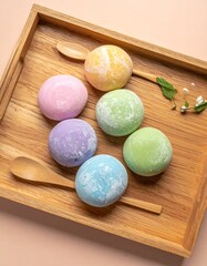 Flat Lay of Japanese Mochi Desserts in Assorted Colors with Powdered Sugar on Neutral Background
