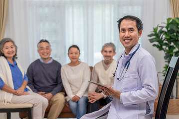 Obraz premium portrait a doctor or psychologist in uniform with stethoscope holding tablet computer,sitting in counselling room,background blurred elderly group therapy