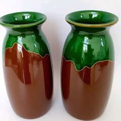 Title:
Two ceramic vases with glossy dark green and brown design accented by golden rim