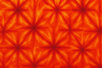 Vibrant watercolor tie-dye pattern with fiery orange and red hues abstract background