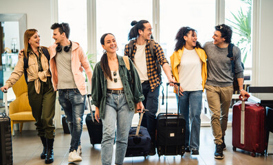 Young group of tourists with suitcases arriving at youth hostel guest house - Happy friends...