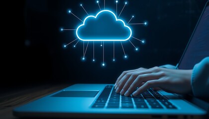 Person typing on laptop with glowing blue cloud technology symbol above cloud computing data