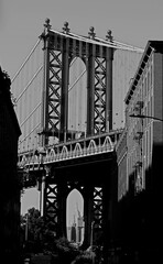 view of Manhattan Bridge tower in new york from the DUMBO neighborhood of Brooklyn with old toned black and white effect