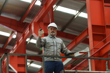Engineers and staff are inspecting systems and components in a metal sheet and metal roofing...