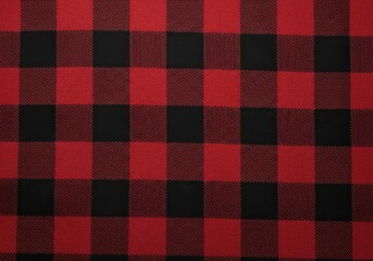 A closeup view of a red and black buffalo plaid pattern, showing the texture and intersecting lines of the fabric