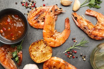 Tasty grilled shrimps with spices on grey table, flat lay. Delicious seafood dish