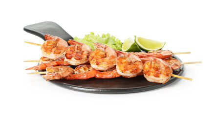 Skewers with tasty grilled shrimps, lime slices and lettuce isolated on white. Delicious seafood dish