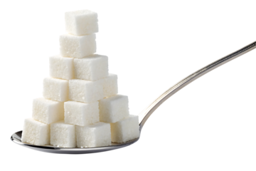 Sugar cubes stacked on a spoon delicately