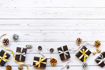 Christmas gift boxes and decorations on wooden table. Preparation for holidays. Copy space. Christmas background.