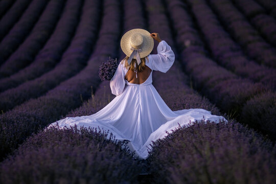 Lavender Fields Woman Dress Provence: Summer photoshoot showcasing elegant woman in white dress amidst purple lavender fields of Provence, France.