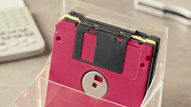 Floppy disc FDD close up, Using diskette for old PC computer macro. Archive programme or Music recorder, playing retro computer games. Vintage device for office, obsolete technology. 