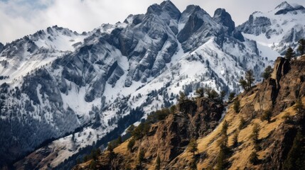 Majestic snow covered mountain peaks with rocky slopes and scattered trees cliffs
