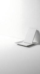 Minimalist White Composition with Plate and Rectangular Object in Studio