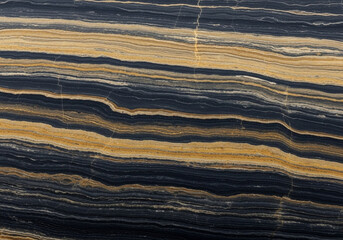 An abstract, high-angle view of a polished stone surface dominates the frame