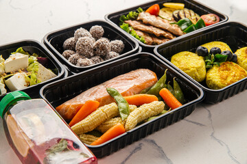 Healthy meal delivery with assorted dishes in plastic containers
