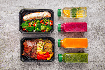 Two meal prep containers with grilled meat and vegetables, surrounded by assorted colorful detox drinks, photographed from above