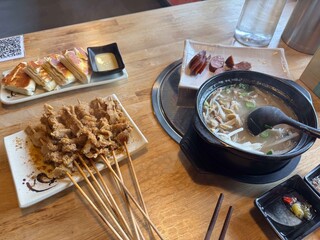 Chinese lamb guts skewers with white soup and sausages.