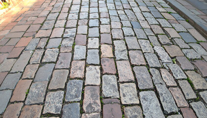 Cobblestone pavement stretches into the distance, showing textures and colors of the aged stone.