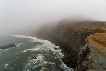 Foggy and Moody View of a Coastal Cliff on the California Coast