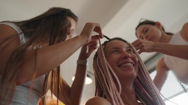Engaging in a Creative Hair Styling Session with Friends for a Fun and Artistic Experience