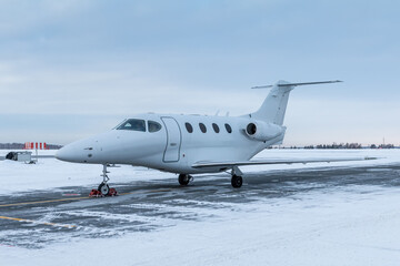 Modern white private jet at winter airport